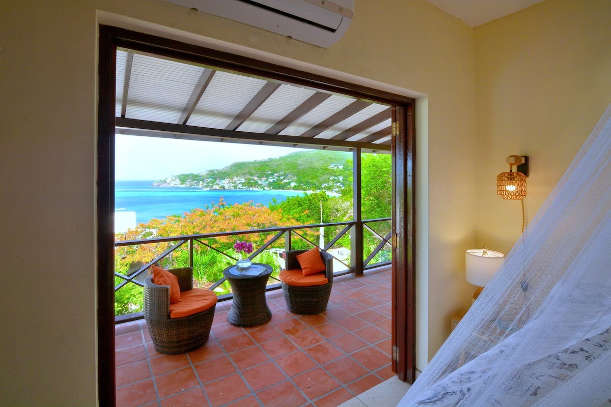 Bedroom Balcony Villa Marisol bedroom with private balcony and Caribbean bay view
